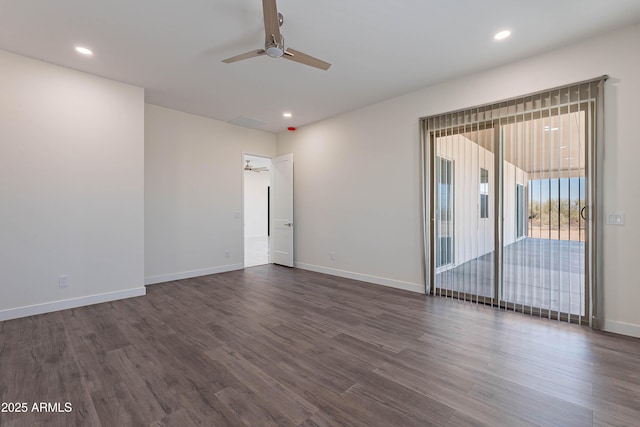 spare room featuring ceiling fan and dark hardwood / wood-style floors