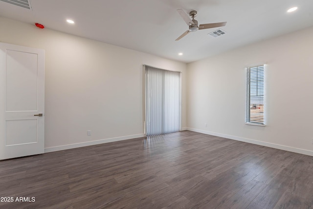 empty room featuring dark hardwood / wood-style floors and ceiling fan