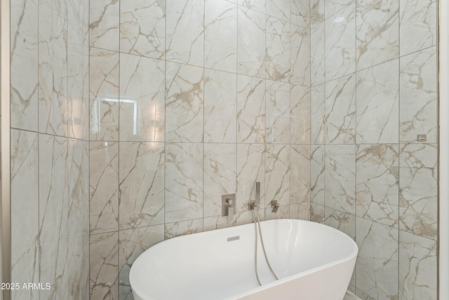 bathroom featuring tile walls and a tub