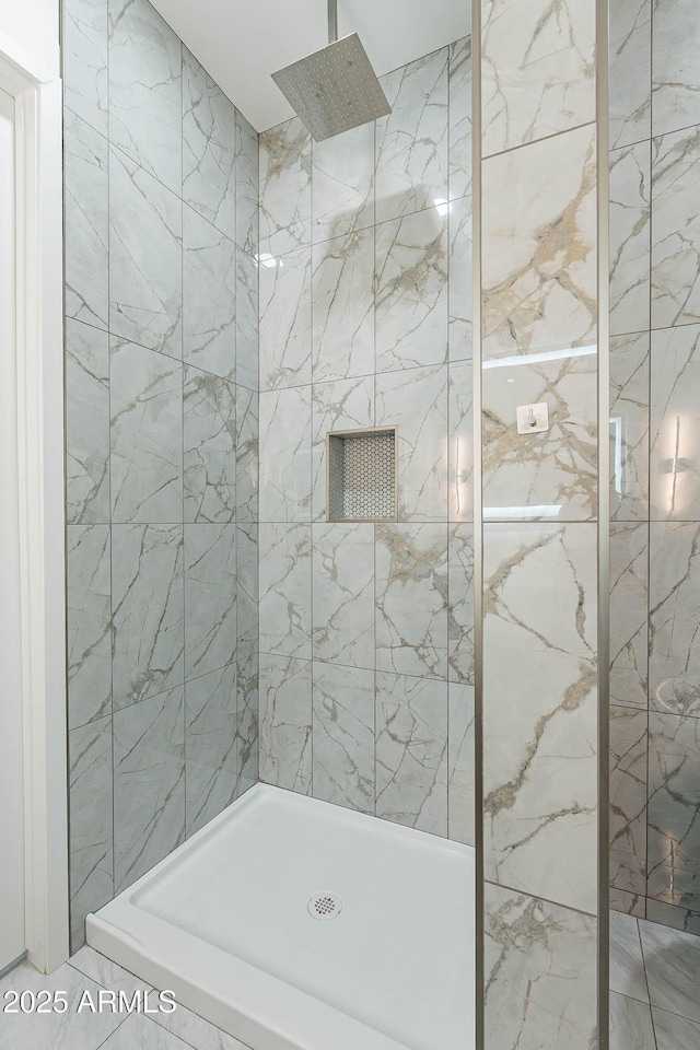 bathroom with a tile shower