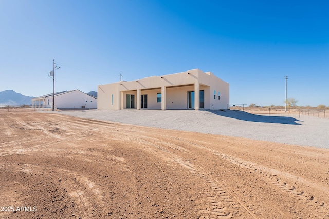 back of house with a mountain view