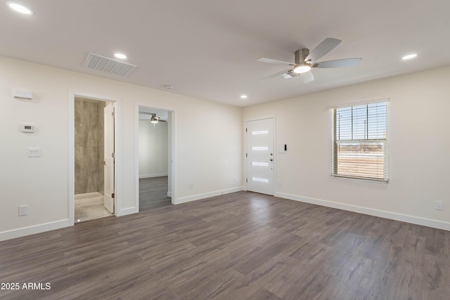 empty room featuring ceiling fan and dark wood-type flooring