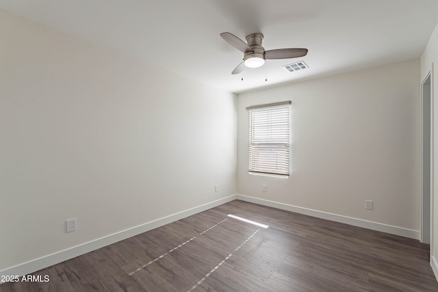 empty room featuring ceiling fan and dark hardwood / wood-style flooring