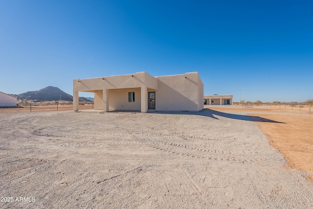 back of house featuring a mountain view and a rural view