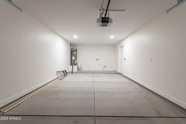 garage featuring electric water heater and a garage door opener