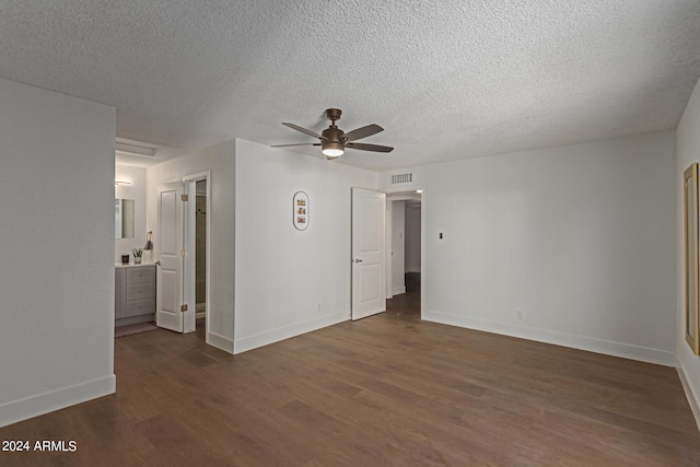 spare room featuring a textured ceiling, dark hardwood / wood-style flooring, and ceiling fan