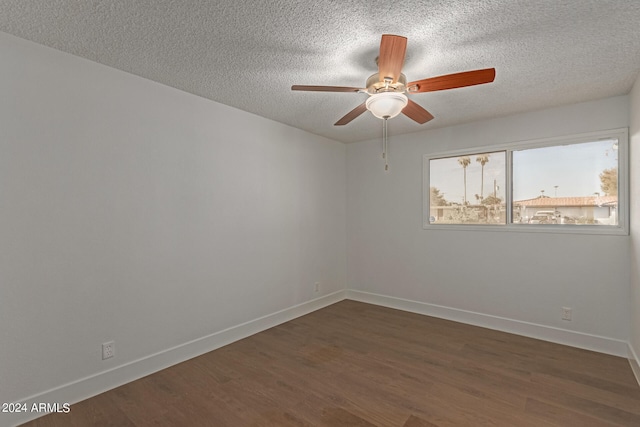 spare room featuring ceiling fan, a textured ceiling, and dark wood-type flooring