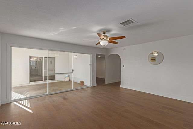 unfurnished bedroom featuring ceiling fan, a textured ceiling, a closet, and hardwood / wood-style floors