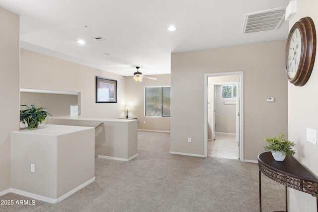 hallway featuring recessed lighting, visible vents, baseboards, and light colored carpet