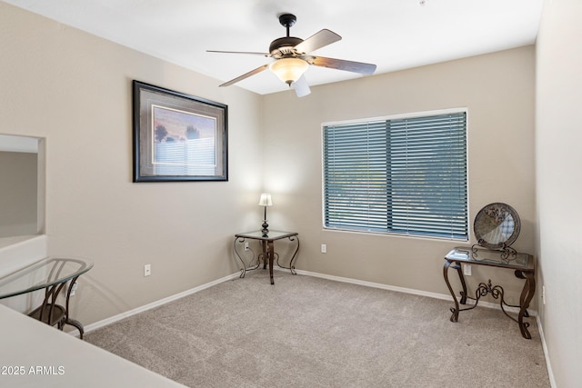 carpeted office with a ceiling fan and baseboards