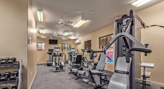 gym featuring a wall unit AC, baseboards, visible vents, and carpet flooring