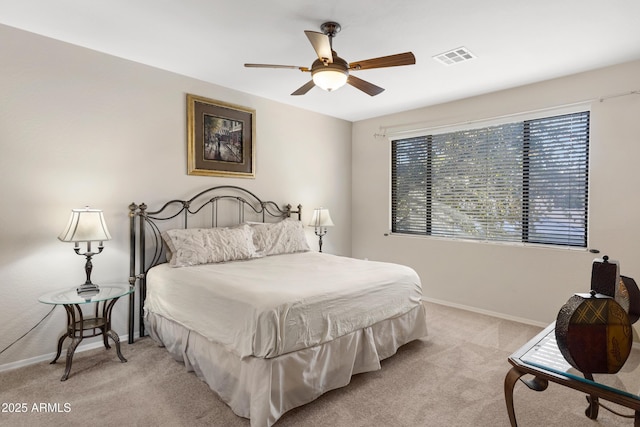 bedroom featuring light carpet, ceiling fan, visible vents, and baseboards