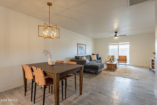 dining area with ceiling fan with notable chandelier