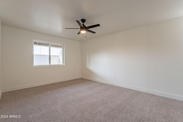 empty room featuring carpet floors and ceiling fan