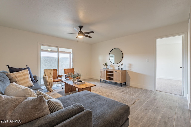 living room featuring light wood-type flooring and ceiling fan