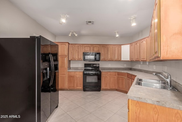 kitchen with light tile patterned floors, light countertops, visible vents, a sink, and black appliances