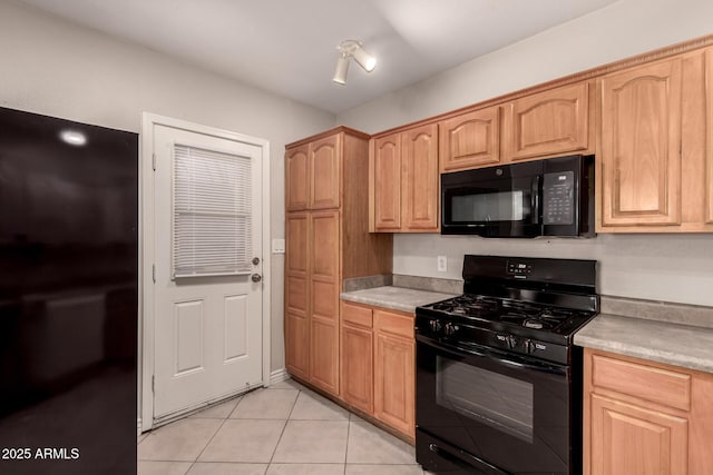 kitchen featuring light brown cabinets, light countertops, black appliances, and light tile patterned flooring