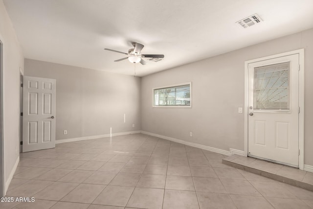 unfurnished room with visible vents, ceiling fan, baseboards, and light tile patterned floors