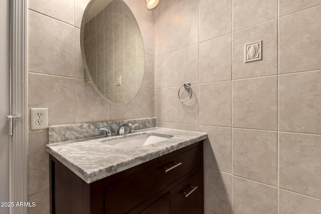 bathroom with tile walls and vanity