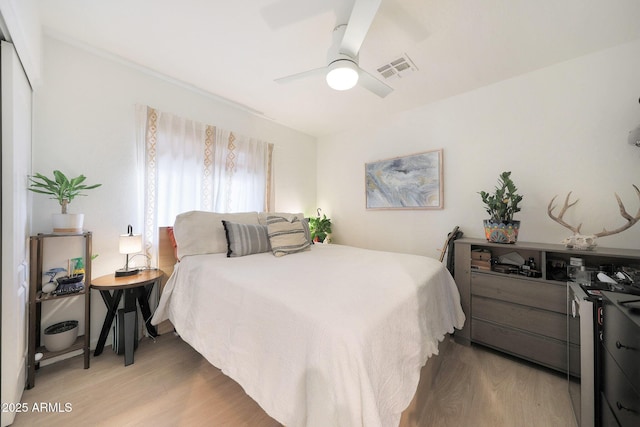 bedroom with wood-type flooring and ceiling fan