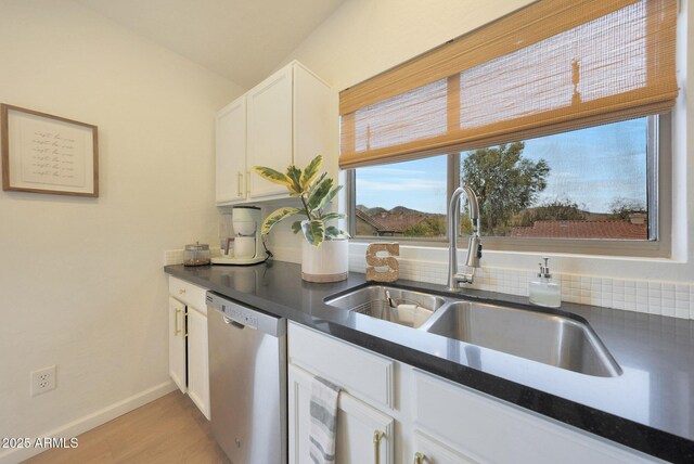 kitchen with dishwasher, sink, white cabinets, and light hardwood / wood-style flooring