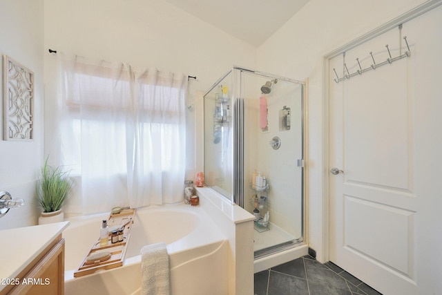 bathroom featuring vanity, shower with separate bathtub, and tile patterned floors