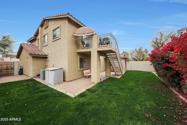 back of house with a patio area, a lawn, and central air condition unit