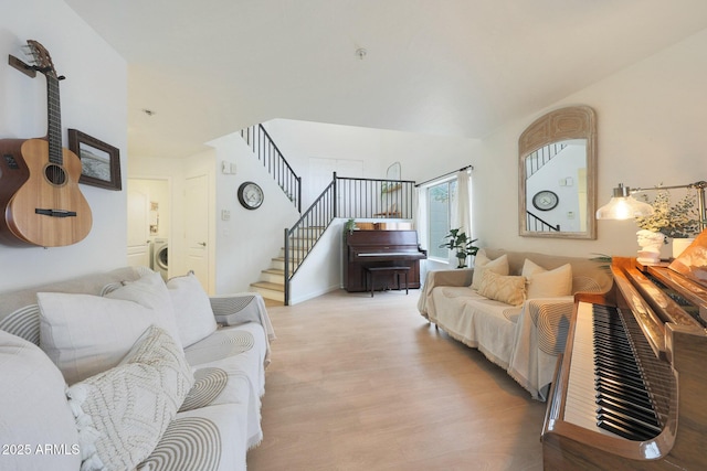 living room with washer / dryer and light wood-type flooring