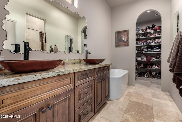 bathroom with vanity and separate shower and tub