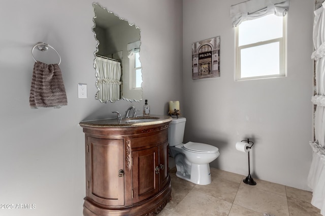 bathroom with tile patterned floors, vanity, and toilet