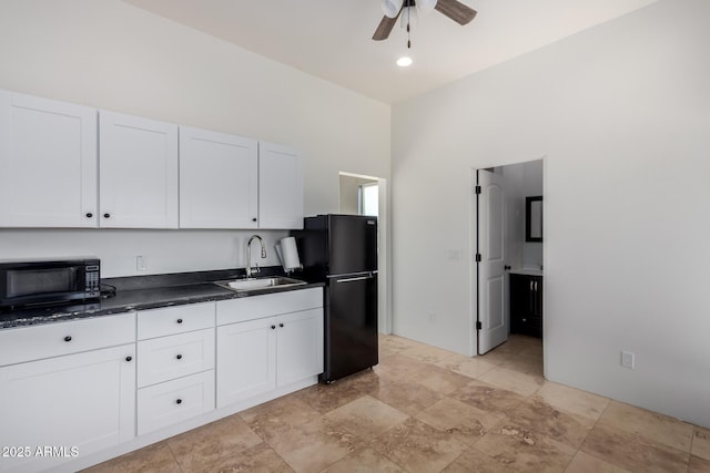 kitchen featuring black appliances, white cabinets, and sink