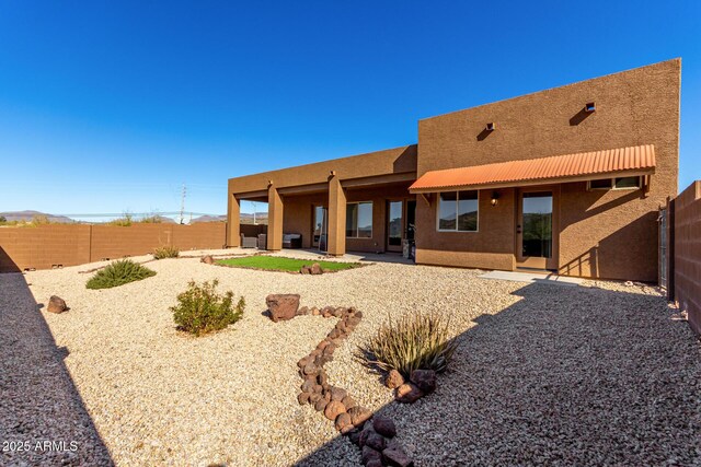 rear view of house featuring a patio