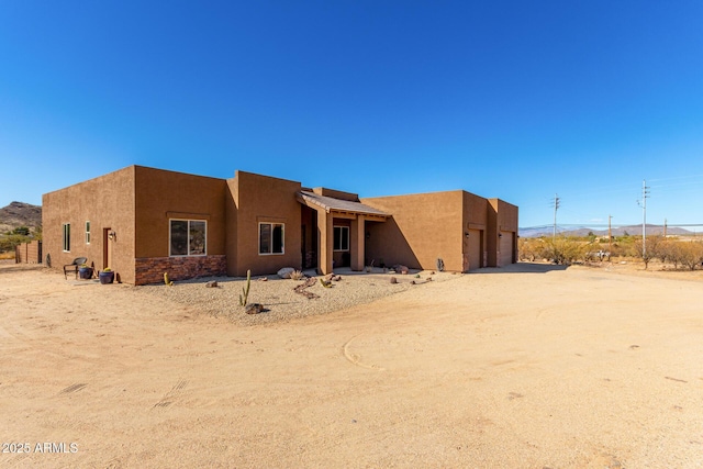 rear view of property featuring a garage