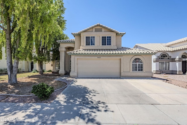 869 W Shellfish Dr, Gilbert, AZ 85233 - mediterranean / spanish-style home with concrete driveway, a tile roof, an attached garage, and stucco siding