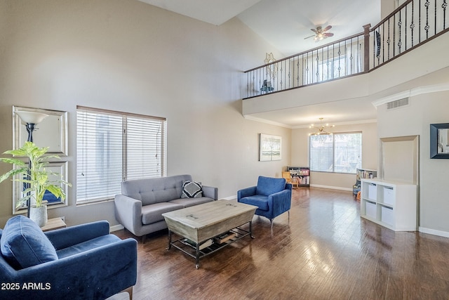 869 W Shellfish Dr, Gilbert, AZ 85233 - living room featuring baseboards, a high ceiling, a chandelier, wood finished floors, and crown molding