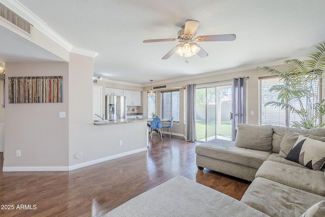 869 W Shellfish Dr, Gilbert, AZ 85233 - living area featuring crown molding, a ceiling fan, baseboards, and dark wood-style flooring