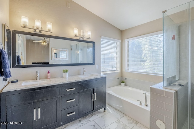 869 W Shellfish Dr, Gilbert, AZ 85233 - full bathroom featuring double vanity, a garden tub, vaulted ceiling, marble look tiles, and ceiling fan
