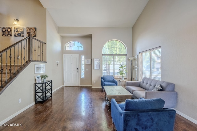 869 W Shellfish Dr, Gilbert, AZ 85233 - living area with plenty of natural light, dark wood-style floors, a towering ceiling, baseboards, and stairway