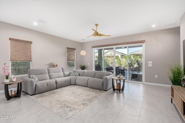 tiled living room with ceiling fan