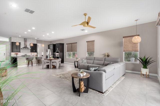 tiled living room with ceiling fan