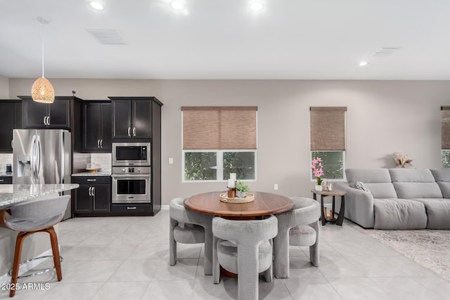 dining area with light tile patterned flooring