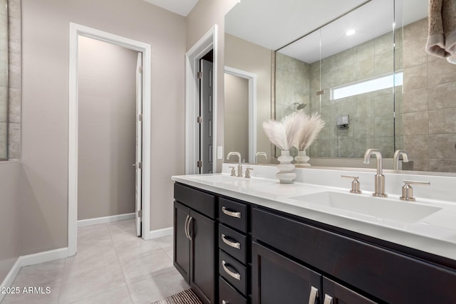 bathroom with vanity, tile patterned flooring, and a tile shower