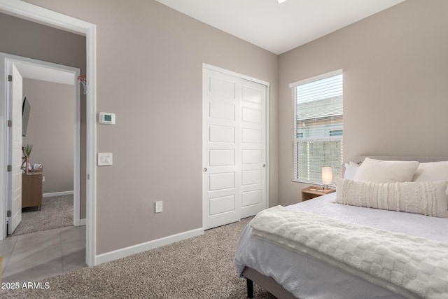 bedroom featuring light carpet and a closet