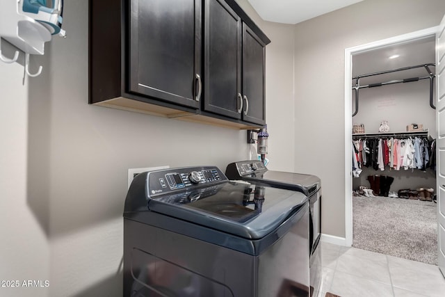 laundry room featuring cabinets, independent washer and dryer, and light colored carpet