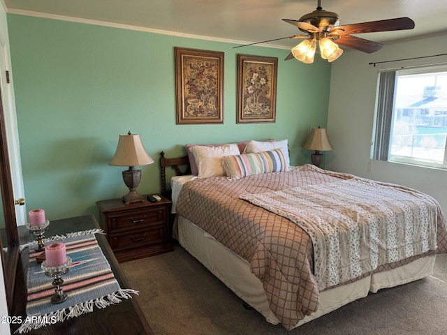 bedroom with carpet floors, crown molding, and a ceiling fan