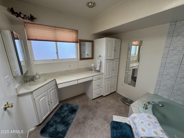 bathroom with a tub and vanity