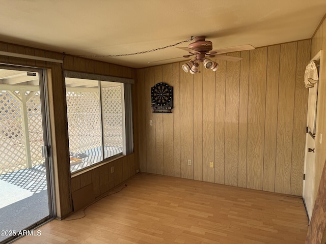 unfurnished sunroom with a ceiling fan