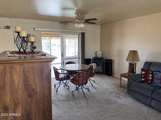 dining space featuring light carpet, ceiling fan, and ornamental molding