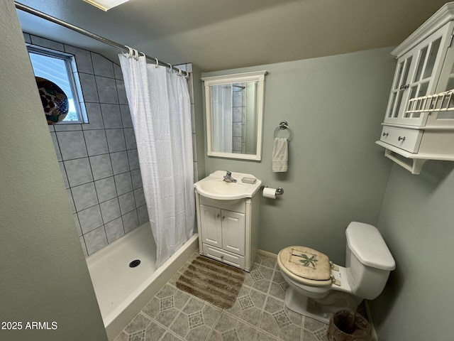 bathroom with toilet, vanity, baseboards, a shower stall, and tile patterned floors
