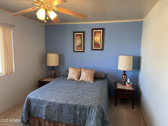 carpeted bedroom with a ceiling fan and crown molding
